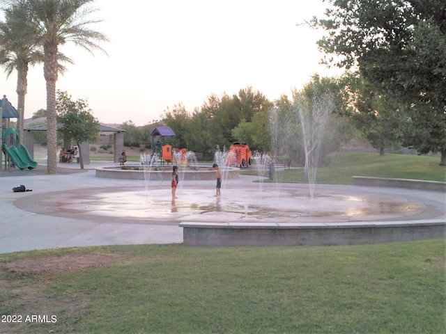 surrounding community featuring a playground and a lawn