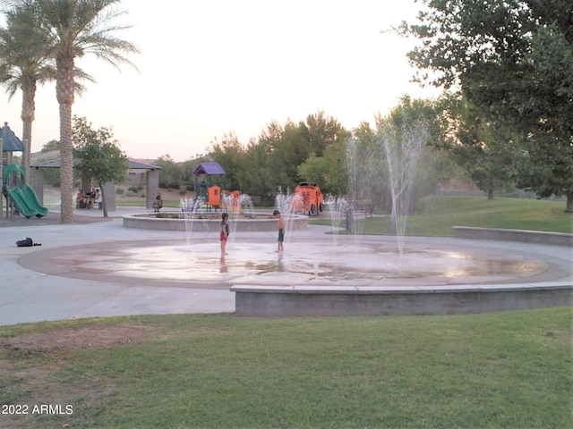 view of community with a lawn and a playground