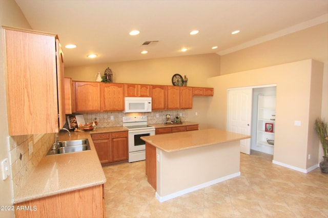 kitchen featuring white appliances, light tile flooring, a kitchen island, backsplash, and sink