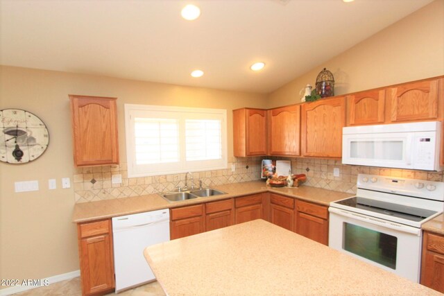 kitchen featuring tasteful backsplash, white appliances, light tile floors, sink, and lofted ceiling