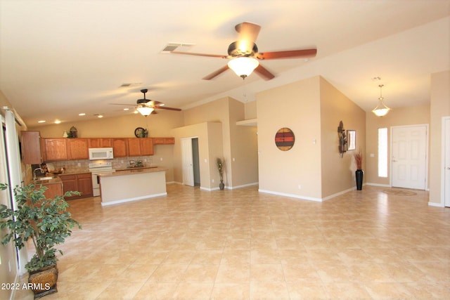 living room with ceiling fan, vaulted ceiling, and light tile floors