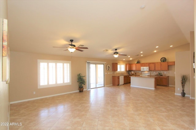 unfurnished living room featuring light tile patterned flooring, ceiling fan, and vaulted ceiling