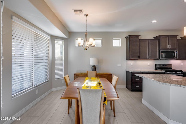 dining space featuring an inviting chandelier