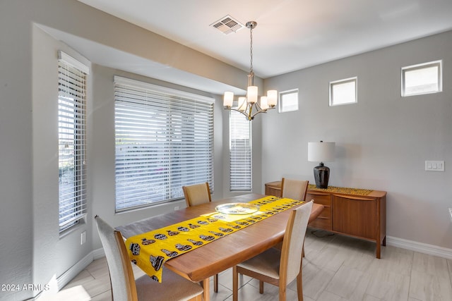 dining room with a chandelier and a healthy amount of sunlight