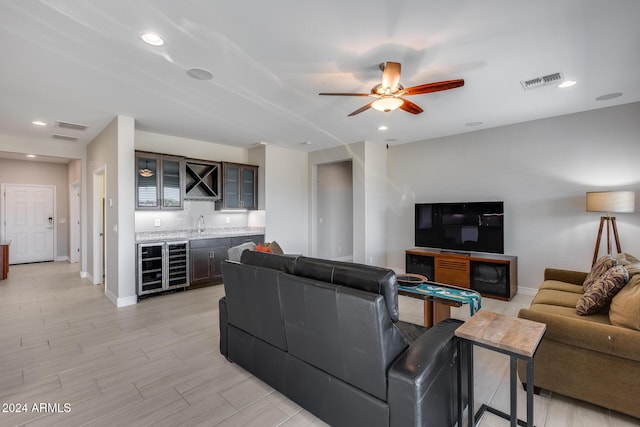 living room featuring bar area, wine cooler, and ceiling fan