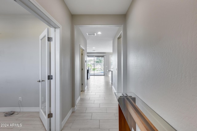 hall featuring light tile patterned flooring