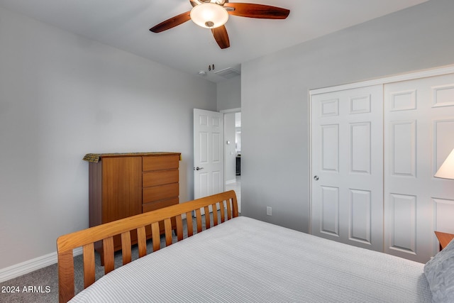 carpeted bedroom featuring ceiling fan and a closet