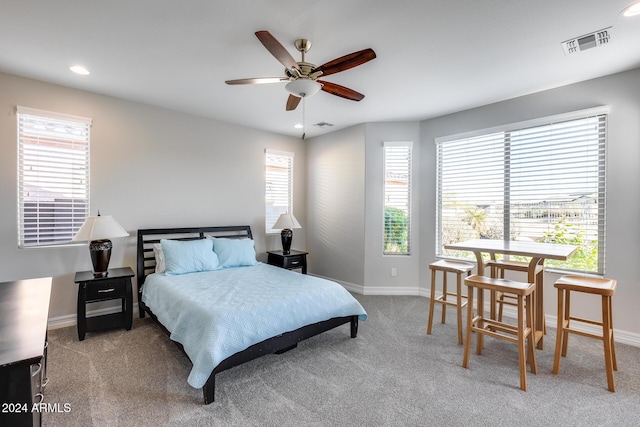 bedroom with ceiling fan and light carpet