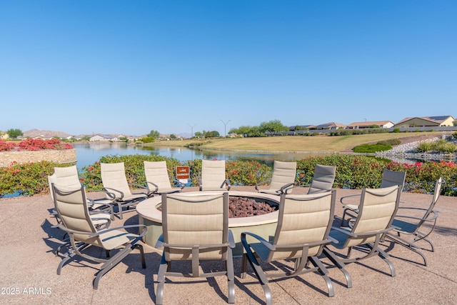 view of patio with a water view and a fire pit