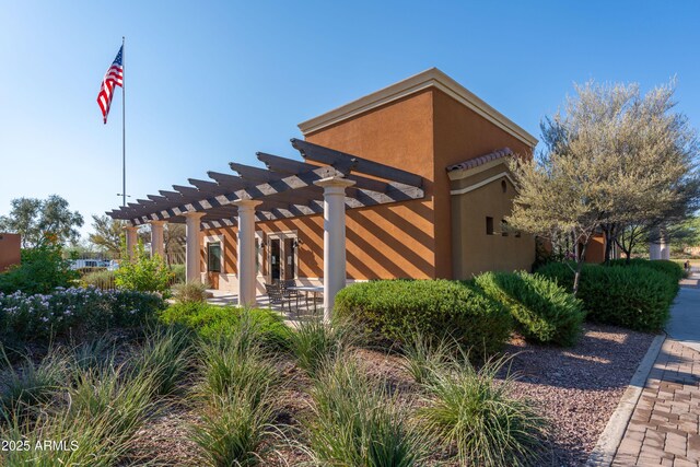 view of home's community featuring a pergola