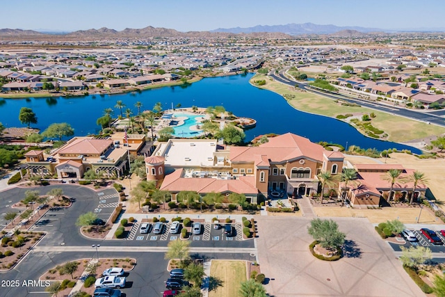 birds eye view of property with a water and mountain view