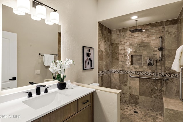 full bathroom with vanity and a tile shower