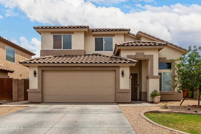 6637 W Watkins St, Phoenix, AZ 85043 - mediterranean / spanish house featuring concrete driveway, stucco siding, an attached garage, and a tile roof