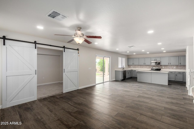 6637 W Watkins St, Phoenix, AZ 85043 - kitchen featuring gray cabinetry, appliances with stainless steel finishes, a barn door, a ceiling fan, and light countertops