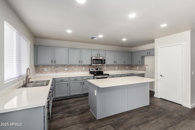 6637 W Watkins St, Phoenix, AZ 85043 - kitchen with appliances with stainless steel finishes, a sink, gray cabinets, tasteful backsplash, and light countertops