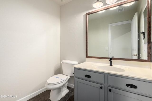 6637 W Watkins St, Phoenix, AZ 85043 - half bath with baseboards, vanity, toilet, and wood finished floors