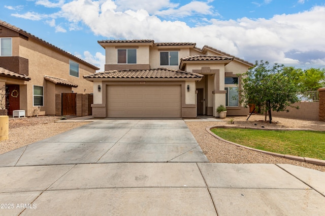 6637 W Watkins St, Phoenix, AZ 85043 - mediterranean / spanish-style house with stucco siding, driveway, a garage, and a tiled roof