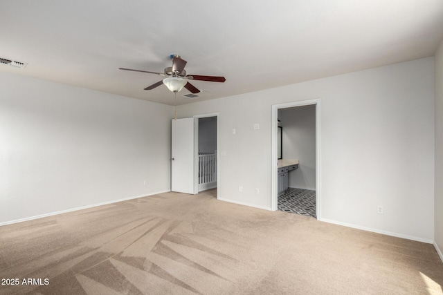 6637 W Watkins St, Phoenix, AZ 85043 - unfurnished bedroom with light carpet, baseboards, connected bathroom, and ceiling fan