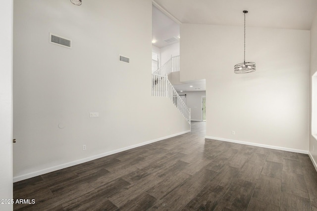 6637 W Watkins St, Phoenix, AZ 85043 - unfurnished living room featuring baseboards, dark wood-style flooring, a chandelier, stairs, and high vaulted ceiling