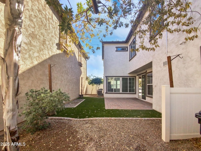 rear view of property with cooling unit and a patio area