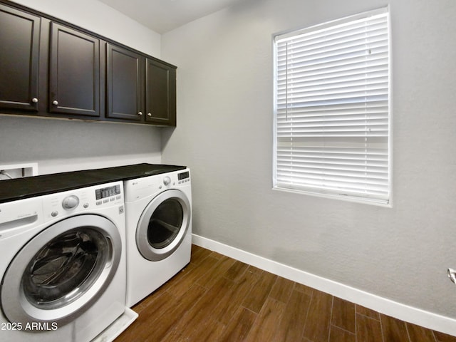 washroom featuring washer and dryer, cabinets, and dark hardwood / wood-style flooring