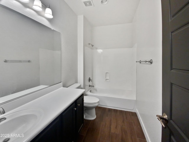 full bathroom featuring hardwood / wood-style floors, shower / bathing tub combination, vanity, and toilet