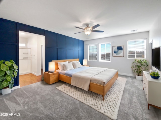 bedroom with ceiling fan and light carpet