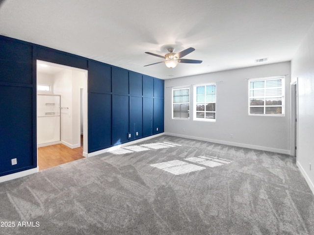 unfurnished bedroom featuring ceiling fan and light carpet