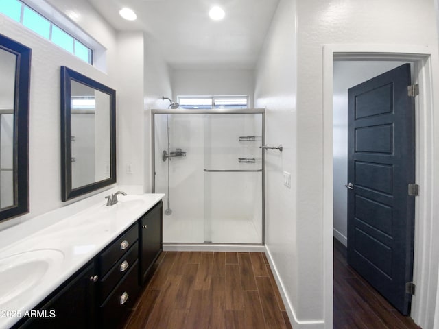 bathroom featuring vanity and a shower with door