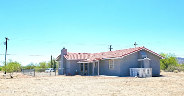 69762 Old Bell Rd, Salome, AZ 85348 - back of property with a tiled roof, stucco siding, and a chimney