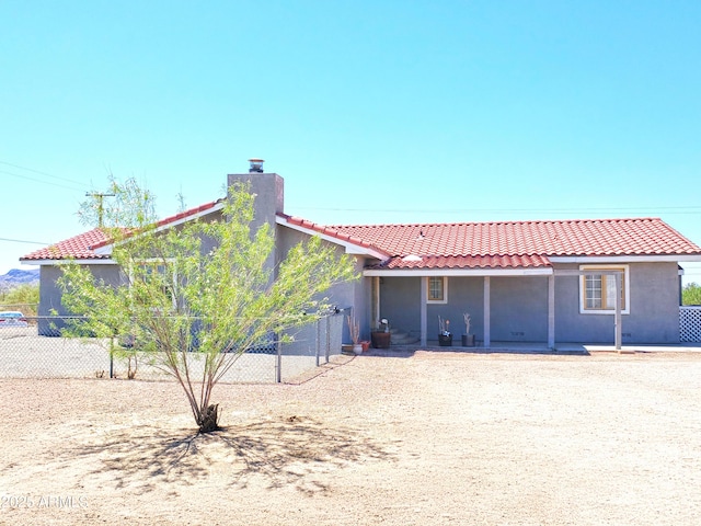 69762 Old Bell Rd, Salome, AZ 85348 - back of property with a chimney, a tile roof, and stucco siding