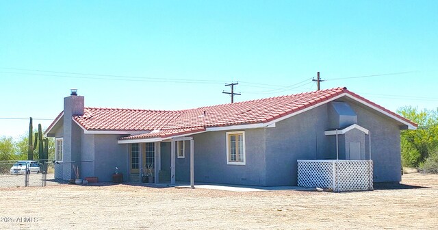 69762 Old Bell Rd, Salome, AZ 85348 - rear view of property featuring a tile roof, stucco siding, and a chimney