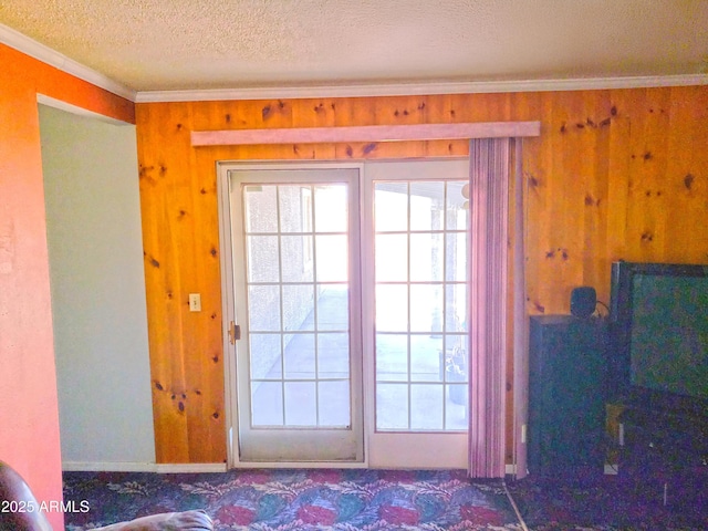 69762 Old Bell Rd, Salome, AZ 85348 - doorway to outside with ornamental molding, wooden walls, healthy amount of natural light, a textured ceiling, and carpet floors