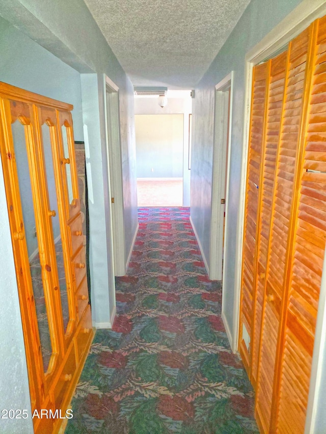 69762 Old Bell Rd, Salome, AZ 85348 - corridor featuring carpet floors, a textured ceiling, and baseboards