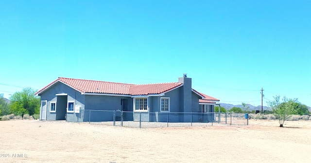 69762 Old Bell Rd, Salome, AZ 85348 - rear view of property featuring a tile roof, stucco siding, and a chimney