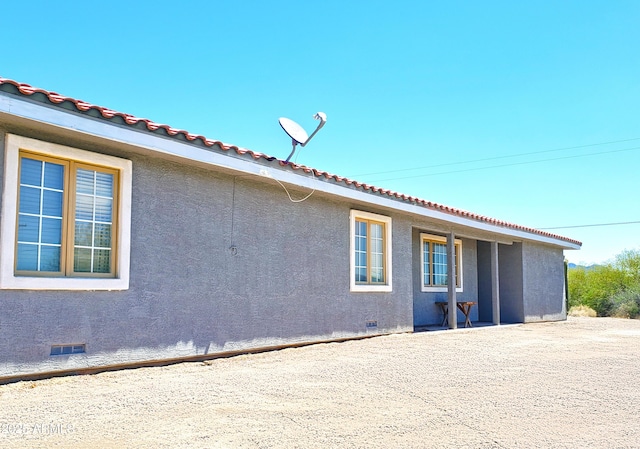 69762 Old Bell Rd, Salome, AZ 85348 - view of home's exterior with crawl space, stucco siding, and a tile roof