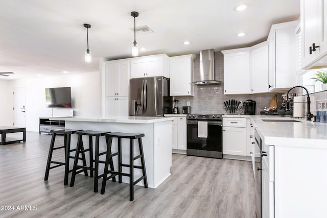 2041 E Harvard Dr, Tempe, AZ 85283 - kitchen featuring stainless steel fridge with ice dispenser, range with electric stovetop, wall chimney exhaust hood, light wood finished floors, and decorative backsplash