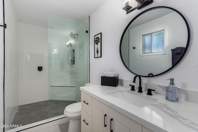 bathroom with vanity, toilet, and a shower with door