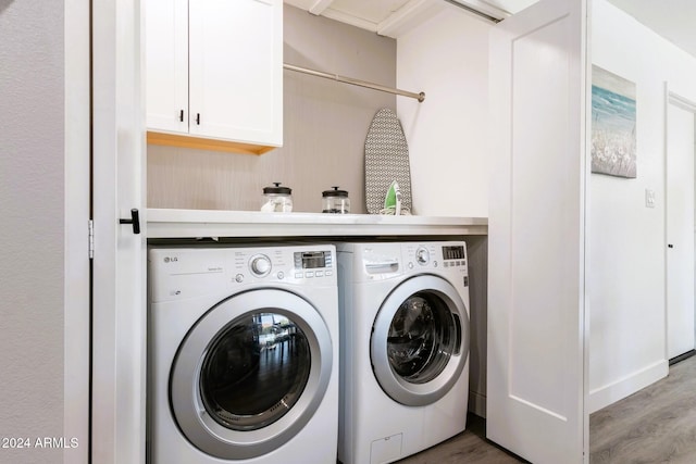 laundry area featuring washer and clothes dryer and hardwood / wood-style floors