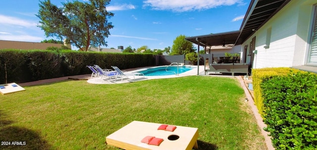 view of yard featuring ceiling fan, a fenced in pool, and a patio