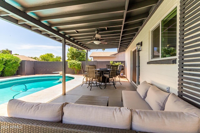 view of pool with outdoor lounge area, ceiling fan, and a patio