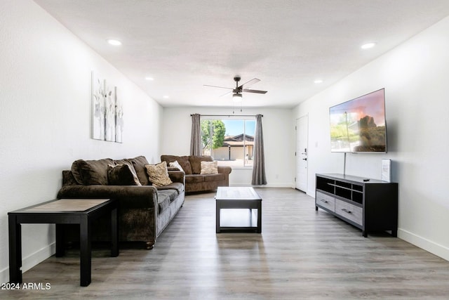 living room with ceiling fan and hardwood / wood-style floors