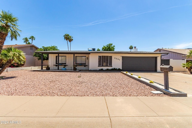 2041 E Harvard Dr, Tempe, AZ 85283 - ranch-style house featuring driveway, an attached garage, board and batten siding, and a porch
