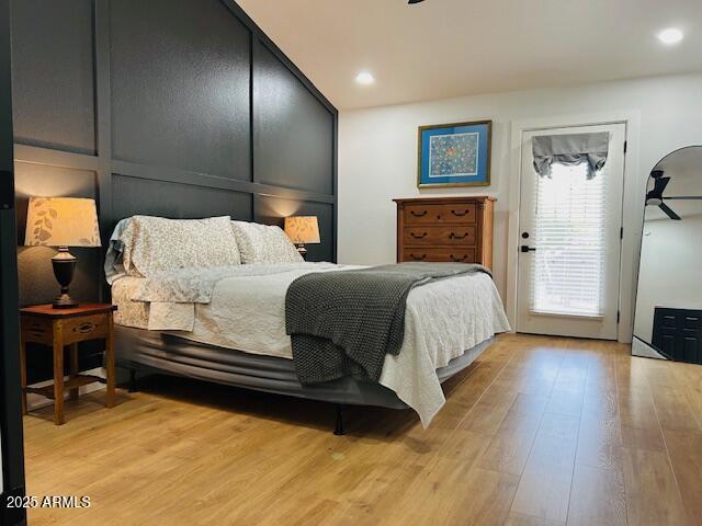 bedroom featuring access to outside and light wood finished floors
