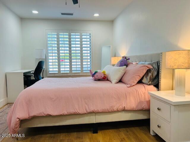 bedroom featuring wood finished floors and recessed lighting
