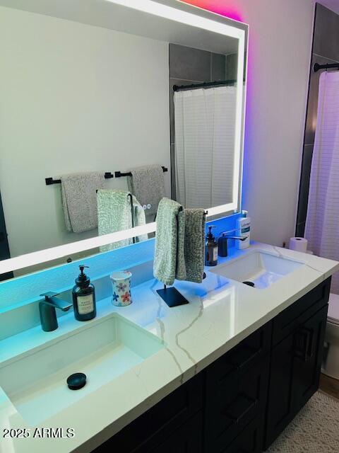 full bathroom featuring toilet, vanity, and curtained shower