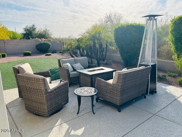 view of patio / terrace featuring an outdoor living space with a fire pit and a fenced backyard