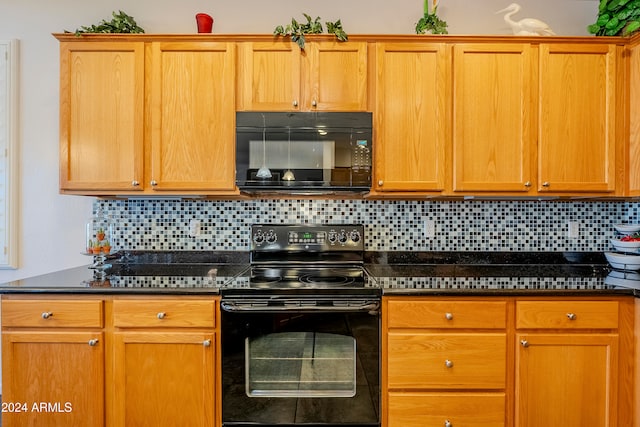 kitchen featuring dark stone counters, decorative backsplash, and black appliances