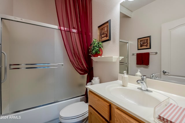 full bathroom featuring vanity, toilet, and bath / shower combo with glass door