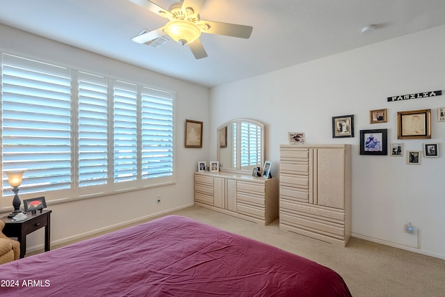 bedroom with ceiling fan and light colored carpet